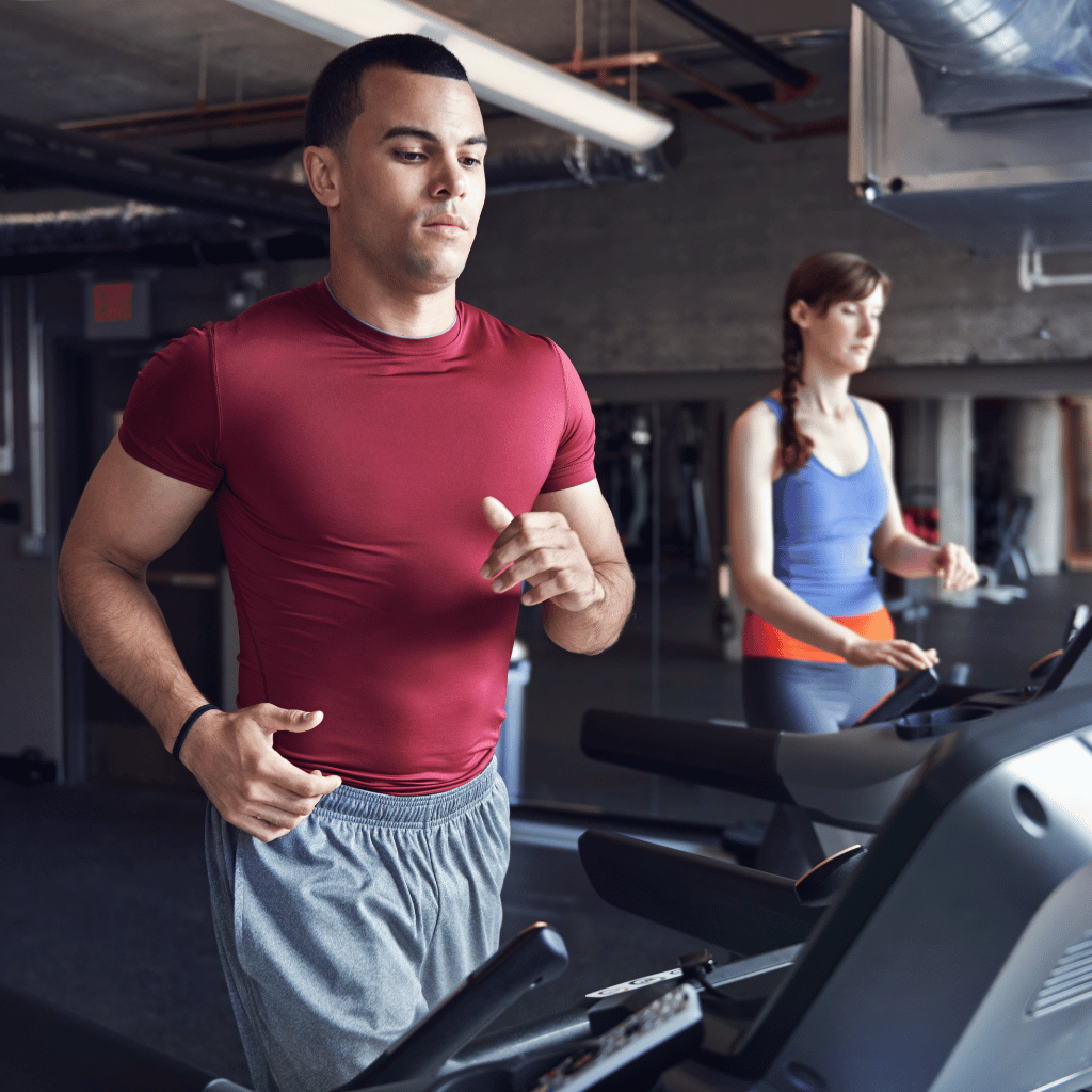 Man and woman walking on treadmills